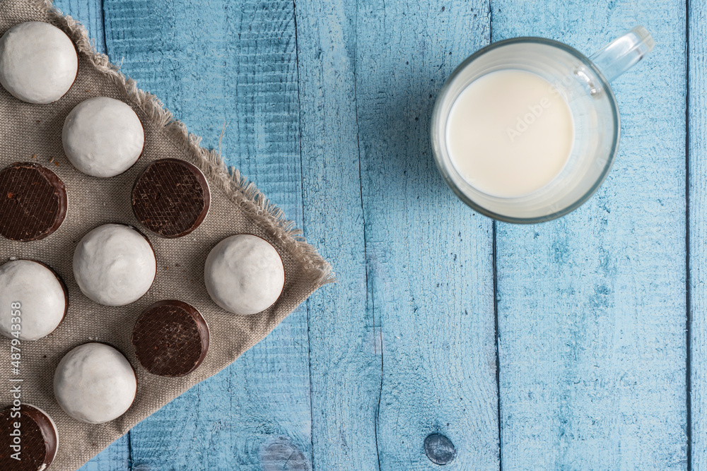 Homemade cookies with nuts, chocolate and milk on a wooden table and art background. Breakfast. Close up.