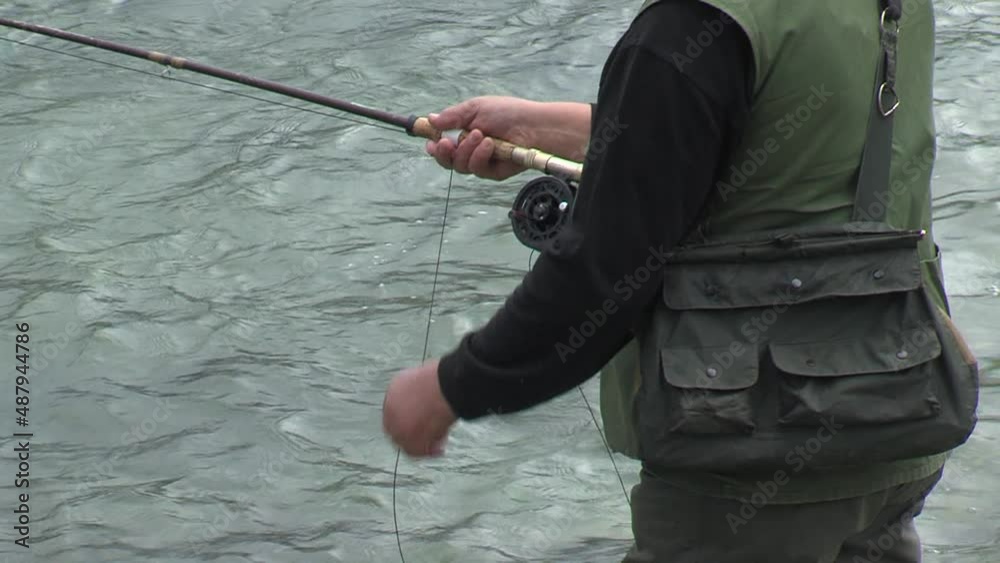 fisherman fishing in river, spinning reel, pulling algae on hook out of water, tilt fisherman fishing in river, spinning reel, pulling algae on hook out of water, tilt