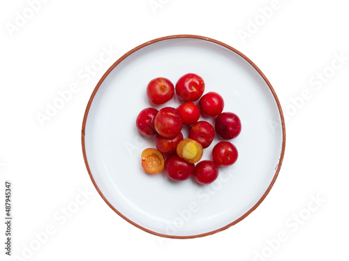 Red Camu Camu fruit on white plate isolated on white background. Camu Camu is a fruit of South American. photo