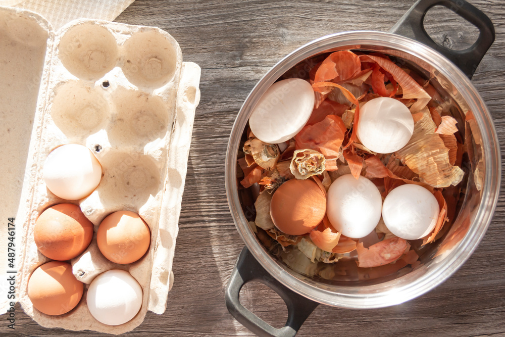 Prepare to paint the egg for Easter. Onion husks, egg and towel are on a wooden table. Prepare to paint the egg for Easter. Onion husks, egg and towel are on a wooden table.
