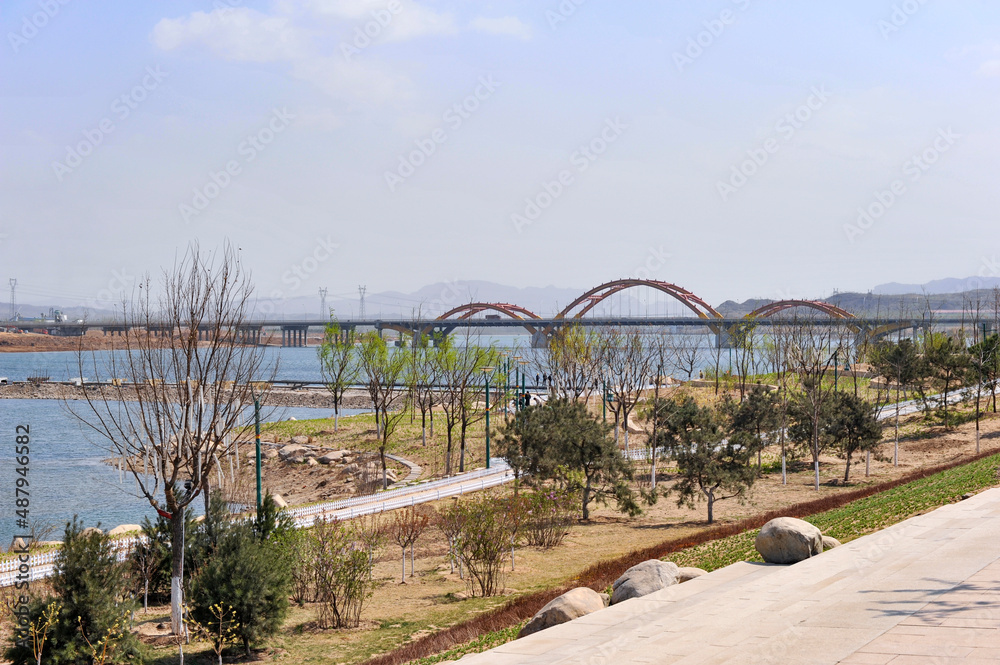 Fototapeta premium Scenery of a large river bank and Bridge