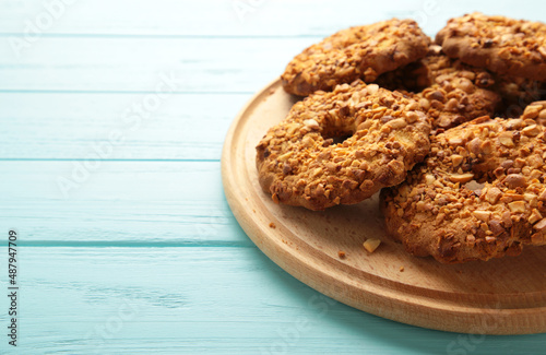 Peanut cookies on cutting board on blue background. Bakery products.