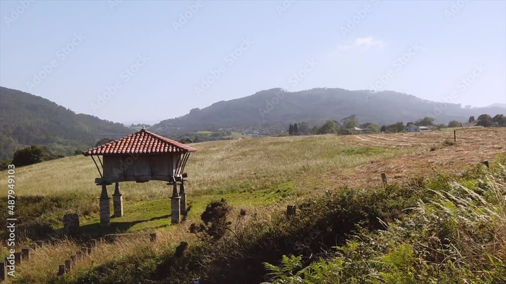 Horreo or elevated stone structure for storing cereals located in a meadow on a farm. Horreo or elevated stone structure for storing cereals located in a meadow on a farm.