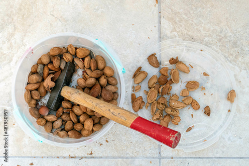 break dry shelled almonds with hammer. hammer and dry almonds, photo