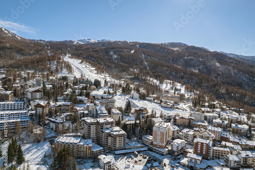 Above view of Sauze d'Oulx mountain village in the Alps Milky Way ski area. ..Sauze d'Oulx, Italy. February 2022