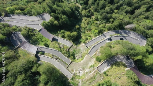 Aerial view cars driving sunny winding road, Susten Pass, Swiss Alps
