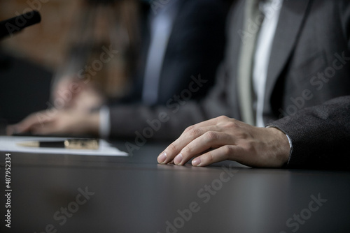 Businessman or politician giving inteview. Close up view gesticulating hands of business man.