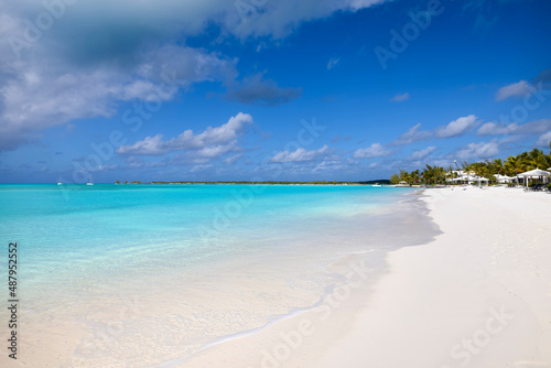 A tropical paradise beach with turquoise sea, blue sky and a Conch shell in the Caribbean Sea as a background or texture