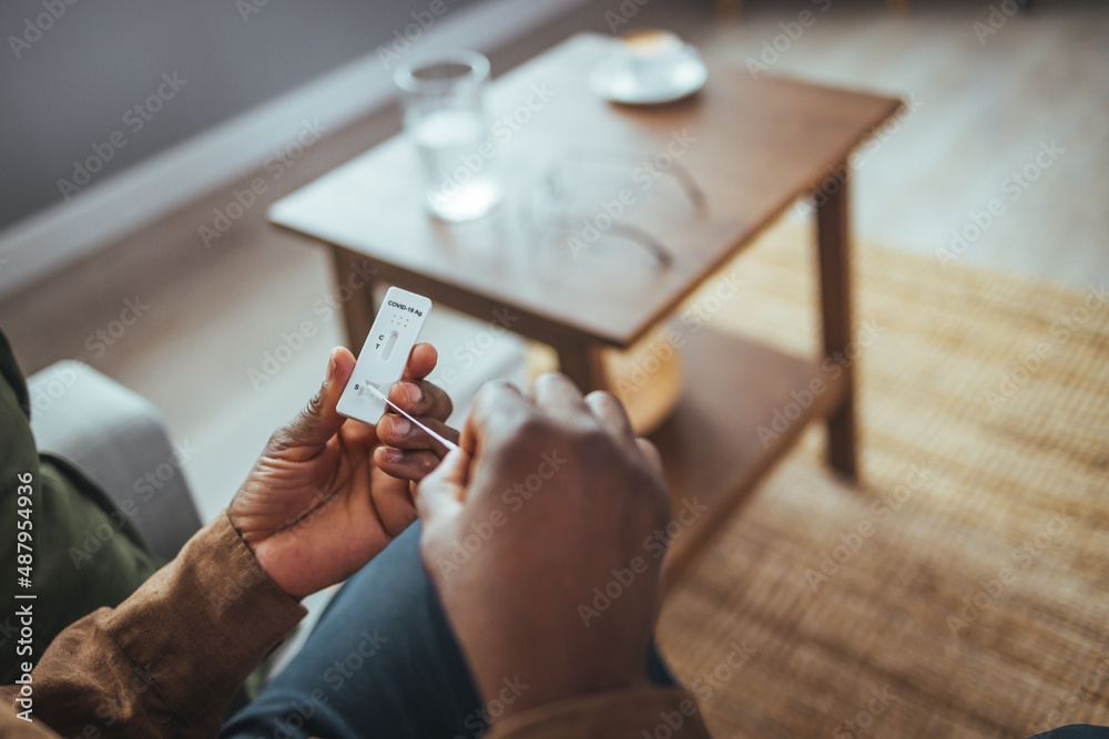 Man self test for COVID19 home test kit. Coronavirus nasal swab test