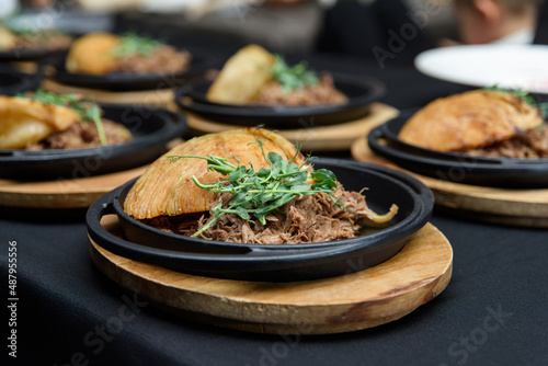 Plate of tasty Swiss dish with venison and cabbage served with herbs and flower petals