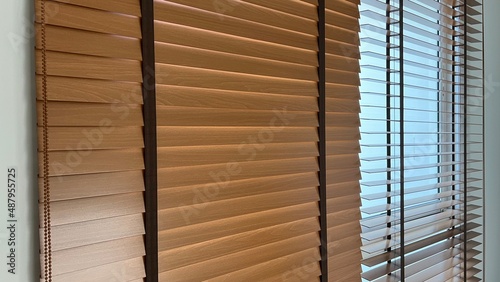 Wooden blinds for interior use on window of house photo