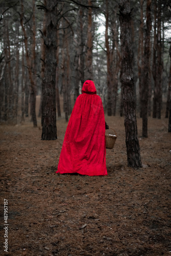 man in a red coat in the forest photo