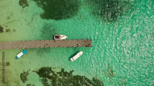 Aerial view boats moored along dock over turquoise ocean, Mexico
