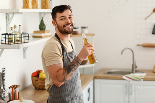 Young bearded man with bott...