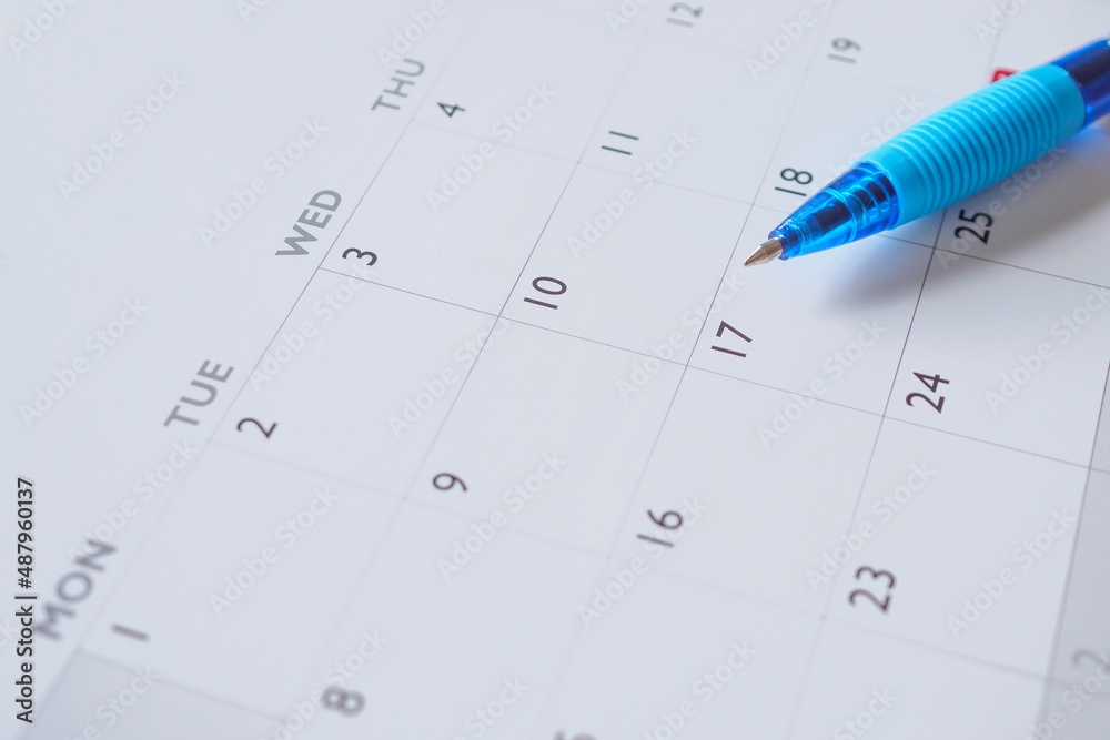 Blue pen on calendar page background business planning appointment meeting concept Blue pen on calendar page background business planning appointment meeting concept