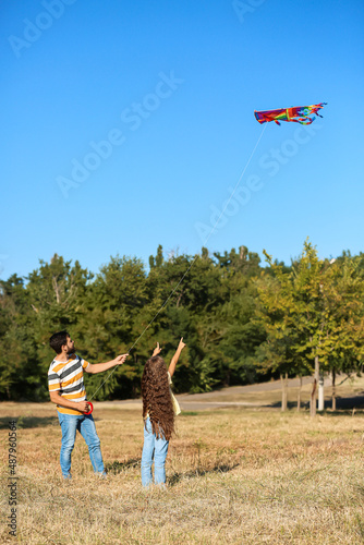 Handsome man flying kite wi...