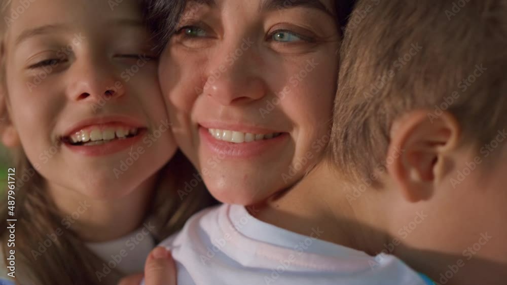 Smiling mother enjoy cuddling with children close up. Happy family moments. Smiling mother enjoy cuddling with children close up. Happy family moments.