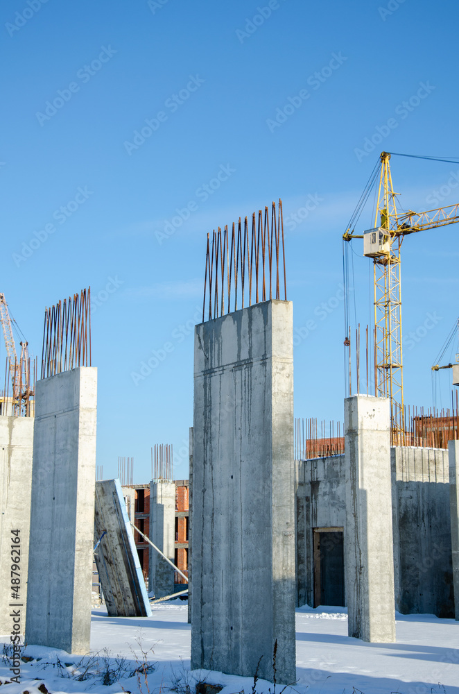 Obraz premium crane tower at construction site. Construction of tall buildings. Construction processes. real construction in the city. The construction of skyscrapers. blue sky on the background.