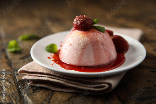 Homemade strawberry panna cotta with berry sauce photo