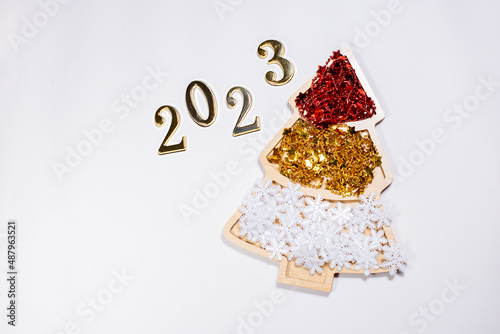 2023 number on white background near new year tree decoration