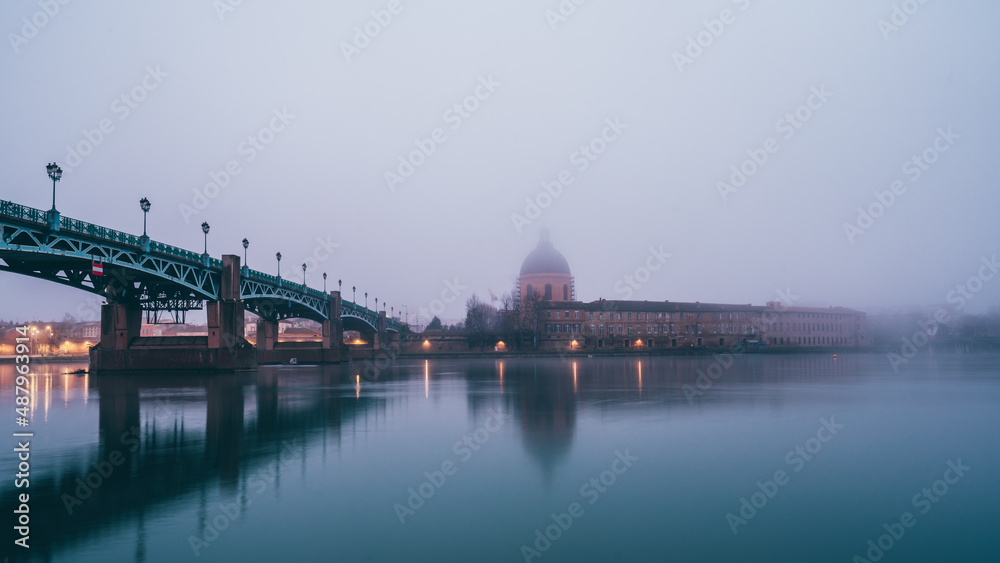 Garonne river and Dome of the 'Hopital de la Grave' at sunrise in fog in Toulouse, France Garonne river and Dome of the 'Hopital de la Grave' at sunrise in fog in Toulouse, France