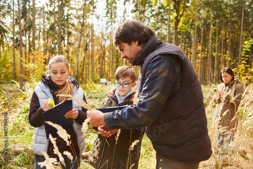 Förster und Kinder beim Baumkunde Unterricht im Wald © Robert Kneschke
