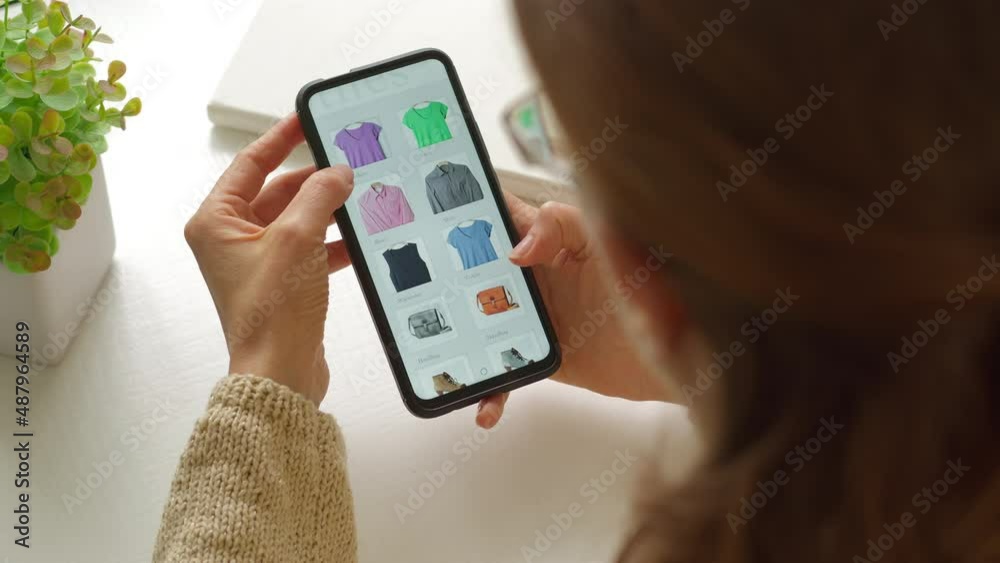 Online shopping using smartphone. A woman buys goods online holding a mobile phone. Online shopping using smartphone. A woman buys goods online holding a mobile phone.