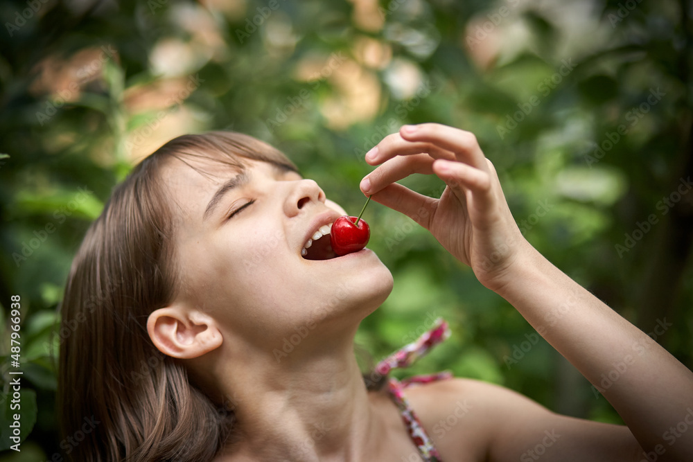 Portrait of laughing little girl eating cherries in the garden Portrait of laughing little girl eating cherries in the garden