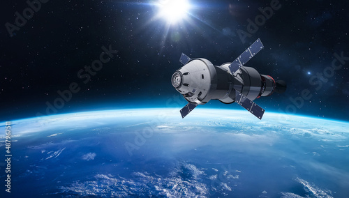 Orion spacecraft on orbit of planet Earth. Sci-fi wallpaper. Artemis space program. Expedition to Moon. Spaceship with astronauts. Elements of this image furnished by NASA
