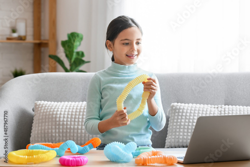 Little girl playing with ye...