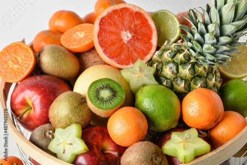 Fototapeta Naklejka Na Ścianę i Meble -  Fresh juicy fruits in wicker basket, closeup