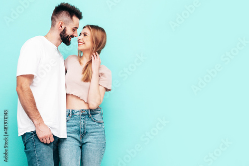 Sexy smiling beautiful woman and her handsome boyfriend. Happy cheerful family having tender moments near blue wall in studio.Pure cheerful models hugging.Embracing each other. Cheerful and happy © halayalex