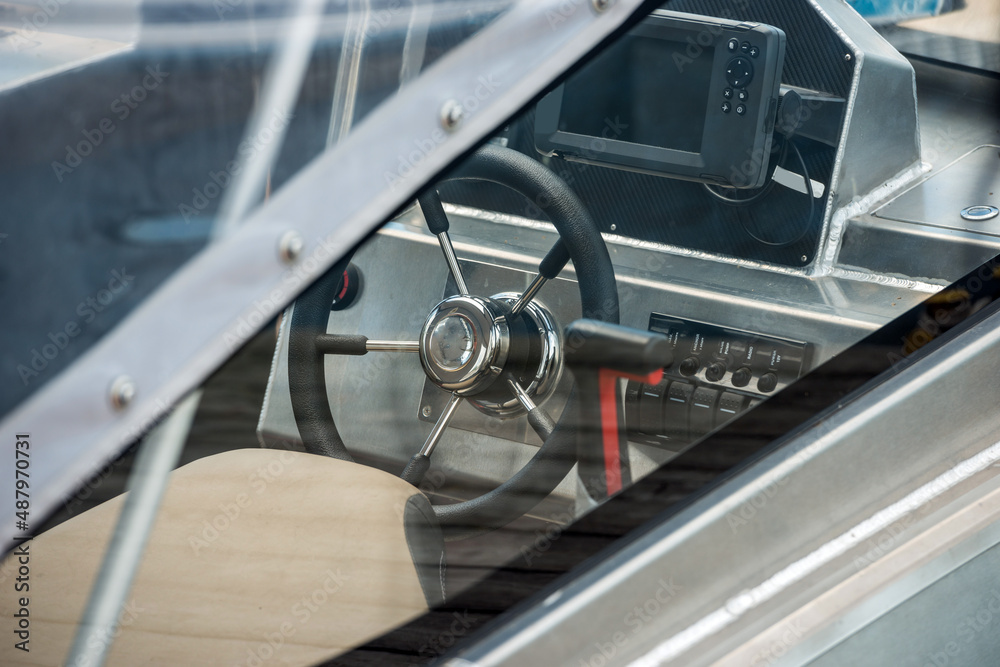 Fototapeta premium Steering wheel in the cockpit of a motor yacht, close-up