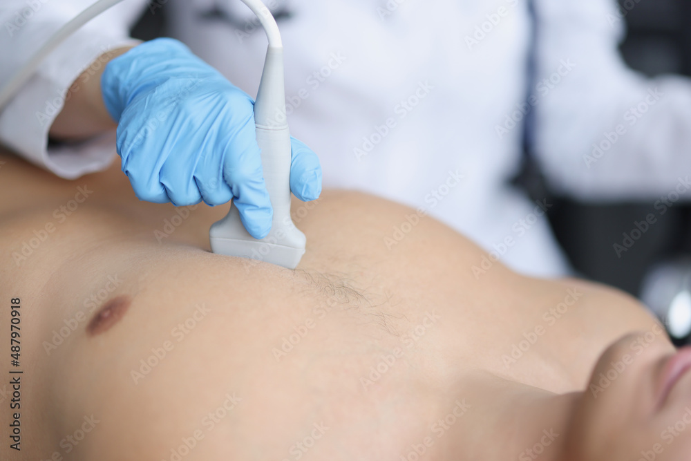 Naklejka premium Hands on the chest of a man, ultrasound of the heart