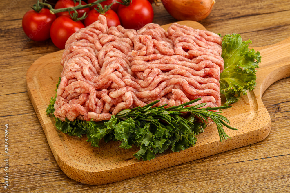 Raw pork minced meat over board Raw pork minced meat over board