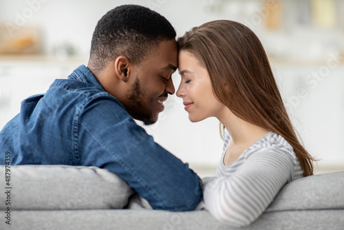 Romantic Moment. Loving Interracial Couple Bonding Together At Home  Closeup Shot