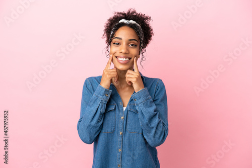 Young latin woman isolated on pink background smiling with a happy and pleasant expression