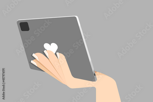 Woman hand holding a tablet with heart shape icon. Vector Illustration