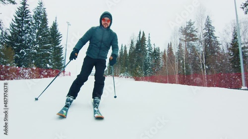 Skier glides down the slope photo