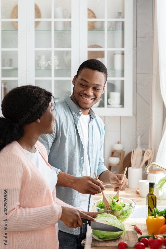 Affectionate African American Couple Cooking Healthy Lunch Together In Kitchen