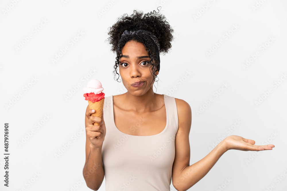 Young african american woman with a cornet ice cream isolated on white background having doubts while raising hands Young african american woman with a cornet ice cream isolated on white background having doubts while raising hands