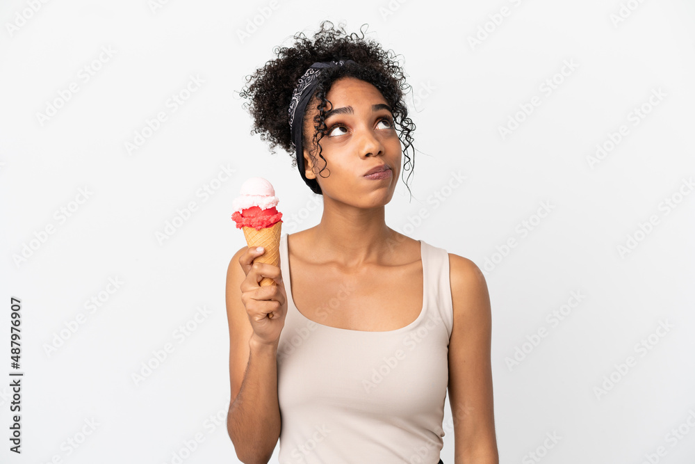 Young african american woman with a cornet ice cream isolated on white background and looking up Young african american woman with a cornet ice cream isolated on white background and looking up