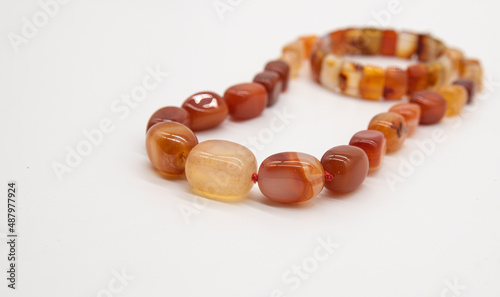 Cuadro en lienzo beads and bracelet made of jasper on a white background