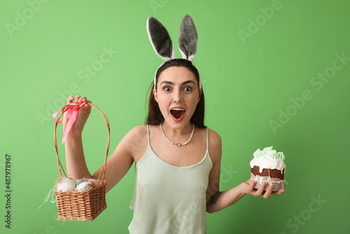 Excited young woman in bunn...