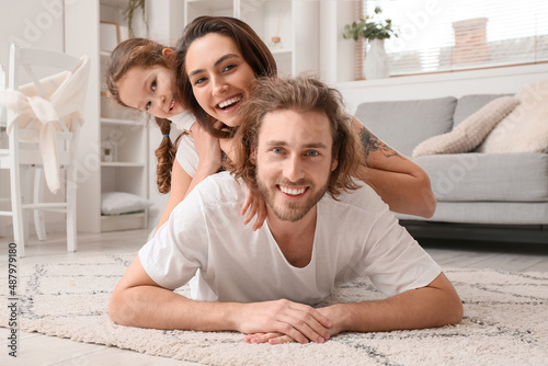 Happy young family lying on...