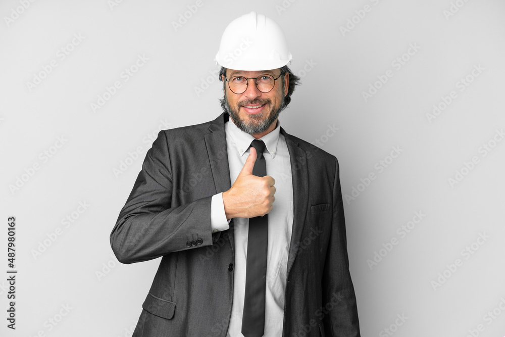 Young architect man with helmet over isolated background giving a thumbs up gesture Young architect man with helmet over isolated background giving a thumbs up gesture