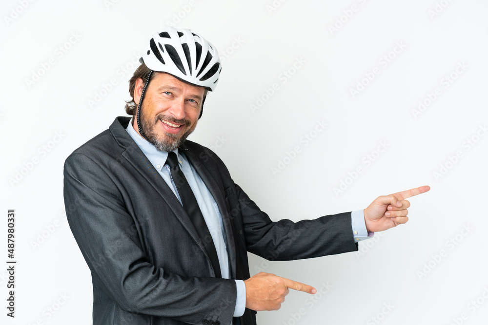 Business senior man with a bike helmet isolated on white background pointing finger to the side and presenting a product Business senior man with a bike helmet isolated on white background pointing finger to the side and presenting a product