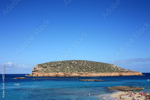 islet of cala conta dipped in the blue of the tourist sea of ​​ibiza in summer photo