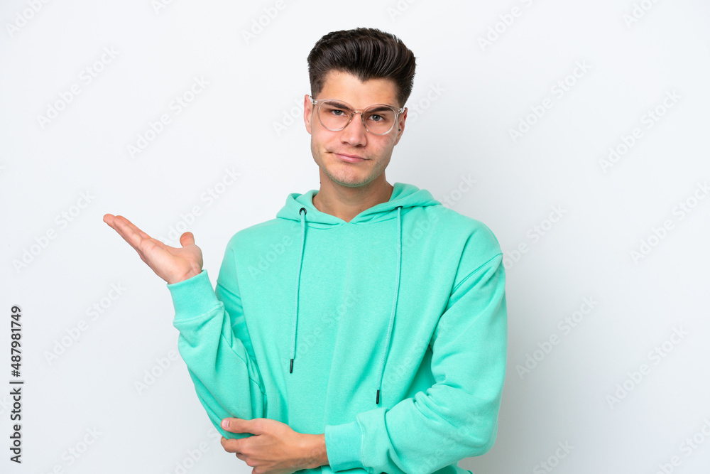 Young handsome caucasian man isolated on white bakcground having doubts Young handsome caucasian man isolated on white bakcground having doubts