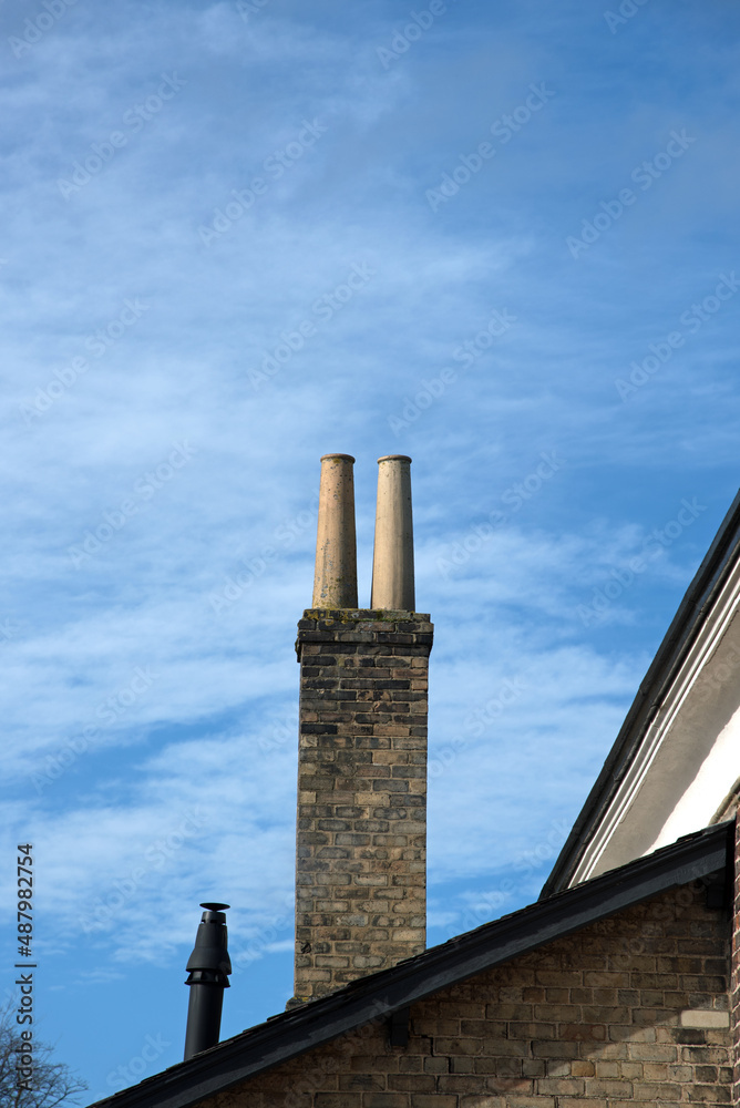 Twin Chimney on a brickwork stack also showing roofline and heating vent